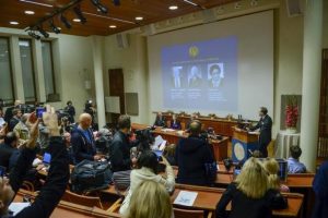 Members of the media take photos of the screen as professor Urban Lendahl announces the 2015 Nobel laureates in medicine during a news conference at the Karolinska Institute in Stockholm