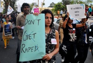 A woman holds a sign as she takes part in the #IWillGoOut rally, to show solidarity with the Women's March in Washington, along a street in Bengaluru, India, January 21, 2017. REUTERS/Abhishek N. Chinnappa